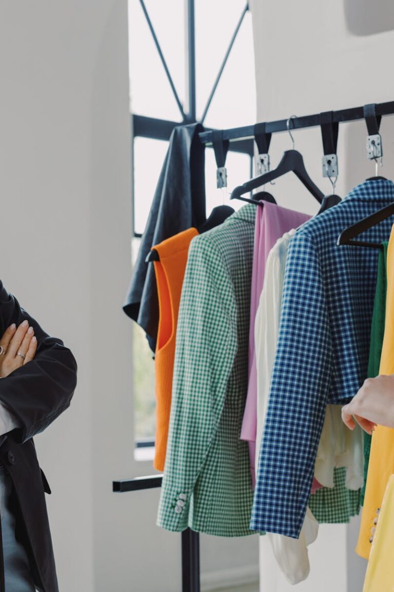 Home Two women browsing colorful clothing racks in a modern boutique.
